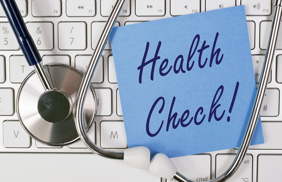 Health Check - blue note paper on keyboard with stethoscope